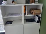 une étagère blanche sur laquelle sont posés plusieurs livres