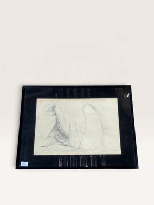 drawing of a woman laying on her stomach in a black frame on a white wall