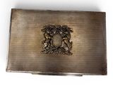 an old silver cigarette case with a coat of arms on it
