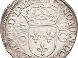 a close up of a coin with a crown on top of it