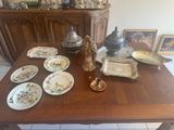 a table with a lot of plates and a vase on it