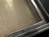 a metal pan with a mesh covering it on a table