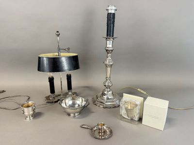 a silver table with a lamp and other items on it