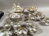 many cups and saucers that are sitting on the table