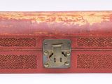 a red box with a lock on it on a white surface