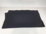 a close up of a black skirt on a white surface