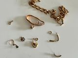 a lot of gold jewelry on a white surface