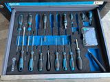 many tools in a tool box on the floor