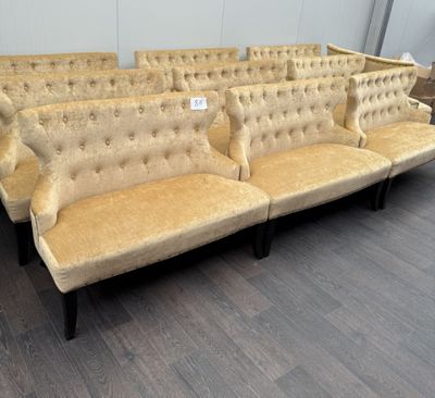 a row of couches in a room with wood flooring