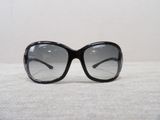 sunglasses on a white surface with a white wall in the background