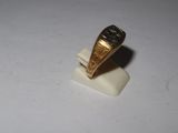 a gold ring on top of a small white object