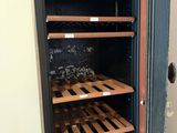 a wine cooler in the corner of a room