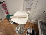 a white chair in the corner of a room with a wooden floor