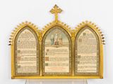 a gold frame with a cross on top of it