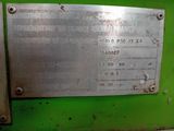 a metal plaque on the side of a green machine