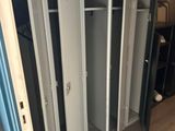 several lockers in a room with a fire extinguisor in the background