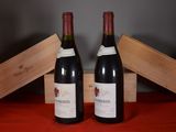 two bottles of wine sitting next to each other on a table