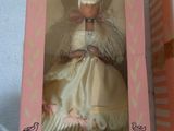 doll in a pink box with a white dress and pink hat