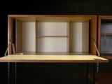 an image of a desk with a shelf and a window