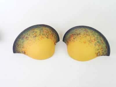 two yellow and black bras sitting next to each other on a white surface