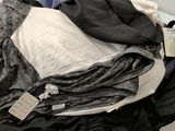 a pile of clothes sitting on a counter next to a mirror