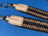 two brown and black lanyards on a blue surface
