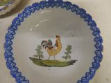a blue and white bowl with a rooster painted on it