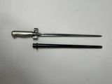 a pair of metal tools sitting on top of a white table