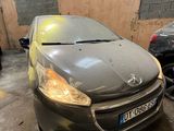 a grey car parked in a garage next to other cars