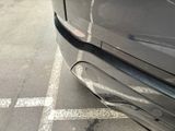 a close up of a car ' s bumper on the street