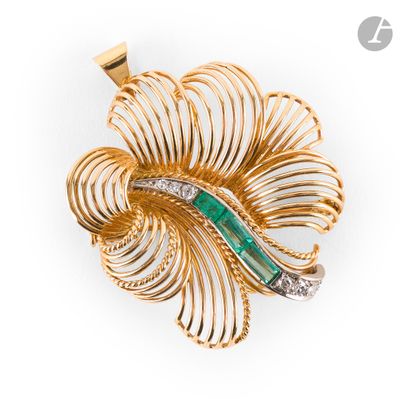 a close up of a brooch with a green stone in it