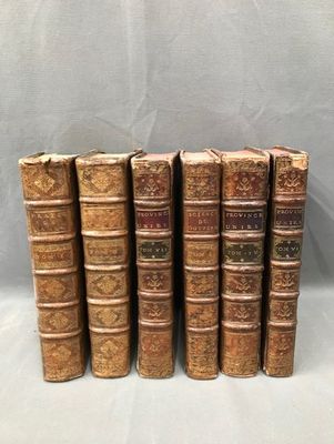 a set of six old books sitting on top of each other