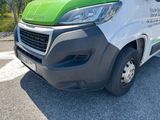 a green and white van parked in a parking lot