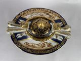 a gold and blue plate with a gold lion on it