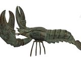statue of a lobster on a stand on a white background
