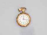 a close up of a gold pocket watch with roman numerals on the face