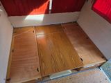 a bed that has been built into the side of a camper