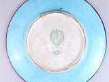 a blue and white plate with a picture of a man on it