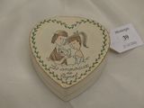 a heart shaped box with a picture of a boy and a girl on it