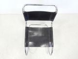 a black chair that is sitting on a white floor