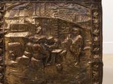 an antique brass chest with a scene of a man and a woman in a stable