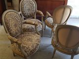 Plusieurs chaises sont alignées dans une pièce, avec une commode en arrière-plan.