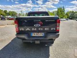 a black truck that is parked on the side of the road