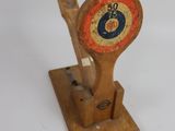 a wooden clock on a stand on a white surface