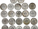 a close up of a bunch of coins with crowns on them