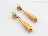 pair of gold earrings with turquoise stones on white background