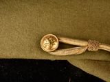 an image of a military hat with a coin on it