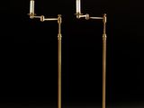 a pair of brass plated floor lamps