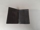 an empty black wallet sitting on top of a white table