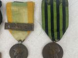 some medals and medals are laying on a white surface
